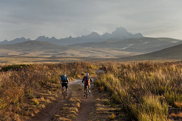 Cyclists riding along Mount Kenya tracks